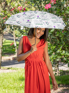 Image of a lady holding a samoyed uv protection umbrella in white