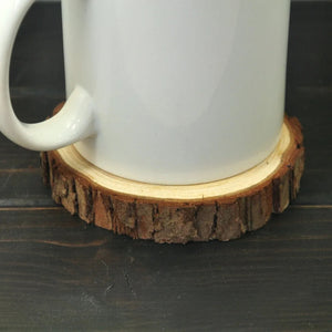 Image of a white cup placed on a dog coaster