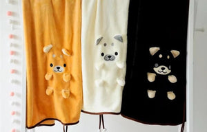 image of a cute samoyed travel blanket - all three colors, black, white, yellow