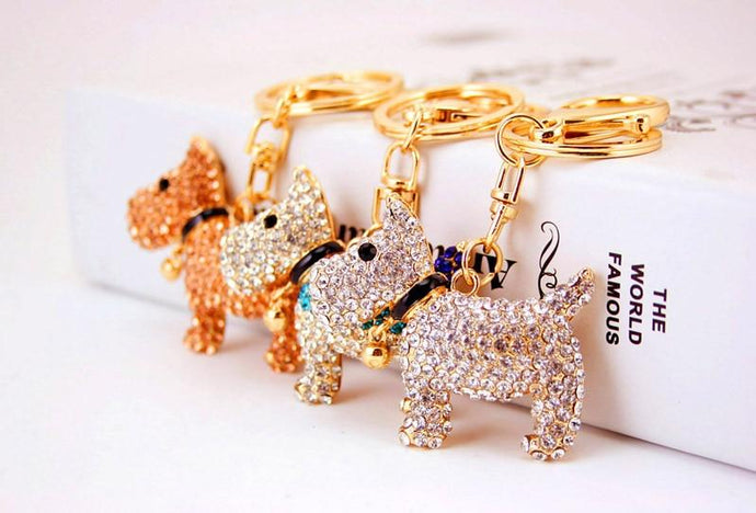 Image of three stone-studded Schnauzer keychains in three colors including White, Brown, and White & Blue