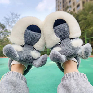 Image of a person wearing silver schnauzer slippers