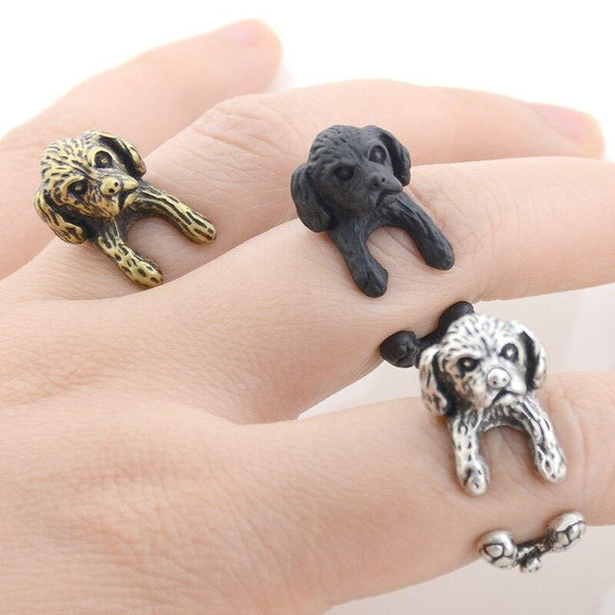 Image of three finger wrap Shih Tzu rings on the finger of a person in three colors including Antique Silver, Bronze, and Black Gunmetal