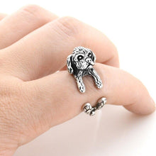 Load image into Gallery viewer, Image of a finger wrap Shih Tzu ring on the finger of a person in the color Antique Silver