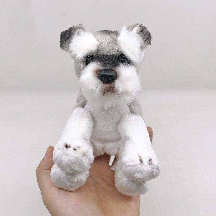 image of an adorable schnauzer stuffed animal plush toy in a women's hand