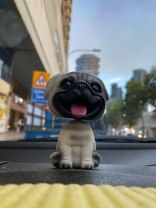 Image of a smiling pug bobblehead
