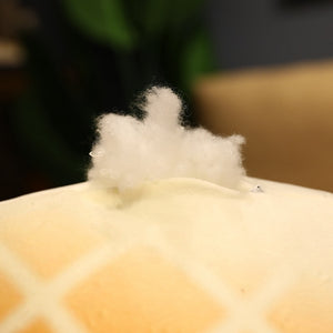 Image of the cotton filling of an adorable bread loaf stuffed American Eskimo Dog plush pillow