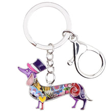 Load image into Gallery viewer, Image of an adorable purple color enamel Dachshund keychain wearing hat, made of enamel
