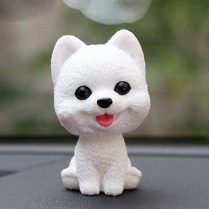 Image of a smiling pomeranian bobblehead in the color white