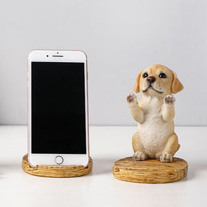 Image of a super cute yellow labrador phone holder made of resin with an iphone placed on it